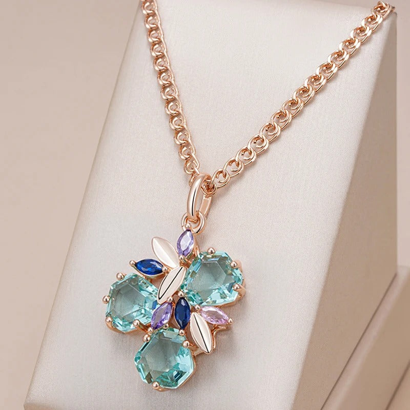 18k rose gold necklace in the shape of a flower with aquamarine stones inlaid